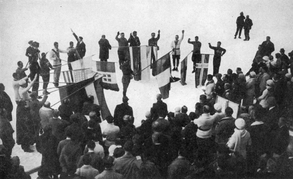 Flagbearers for each of the participating nations at the 1924 Winter Olympics take the athlete's oath; spoken by the French biathlete Camille Mandrillon (center)